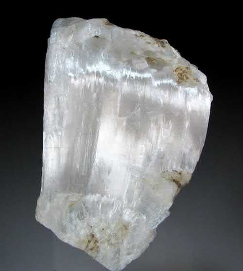 FIGURE 3. Solid piece of satiny-white ulexite, NaCa[B5O6(OH)6] 5H2O, composed of tightly compact optical fiber-like crystals, 6 3 4 3 3.5 cm.