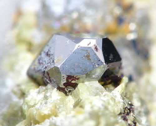 FIGURE 5. Well-formed, complex 3 mm lustrous silvery crystal of sperrylite, PtAs2.